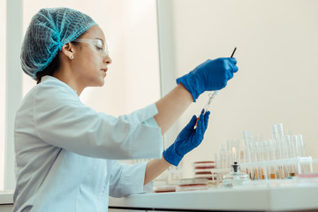 Wall Mural - smart dark haired woman working in the lab