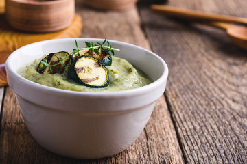 Wall Mural - Healthy zucchini cream soup in ceramic bowls