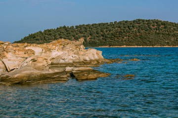 Wall Mural - summer vacation beautiful destination for swimming and rest on a fresh air nature scenery landscape place in Greece Eastern waterfront district with rocky stone shoreline and forest island coast  