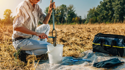 Soil Sampling. Woman Agronomist Taking Sample With Soil Probe Sampler