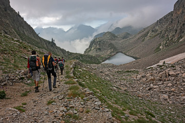 Wall Mural - hikers on a mountain trail in the maritime alps in the morning.