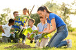 © New Africa - Kids planting trees with volunteers in park