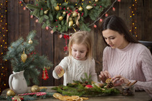 Mother And Daughter Make  Christmas Wreath