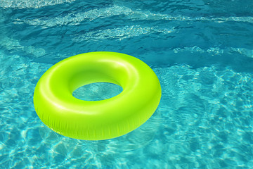 Wall Mural - Bright inflatable ring floating in swimming pool on sunny day. Space for text