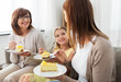 © Syda Productions - family, generation and food concept - smiling mother, daughter and grandmother eating cake at home