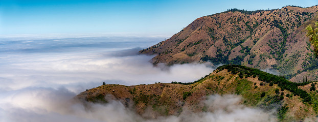 Wall Mural - Clouds around Mountains from View