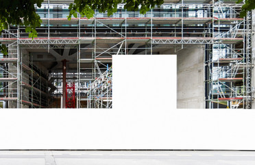 Construction site with blank construction fence billboard