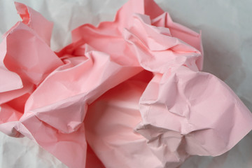 Wall Mural - Ball of pink paper on white sheet