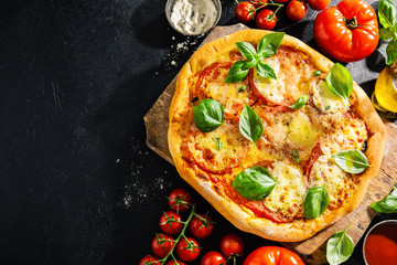 Wall Mural - Homemade pizza with mozzarella on dark background