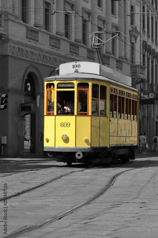 tram giallo a milano in italia, yellow streetcar in the downtown of milan city in italy  - obrazy, fototapety, plakaty 