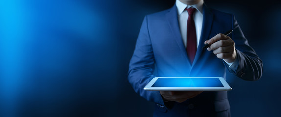 Businessman holding digital tablet. Man using gadget in office