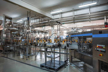 Wall Mural - Automatic conveyor belt of production line of juice on beverage plant or factory, modern computerized industrial equipment