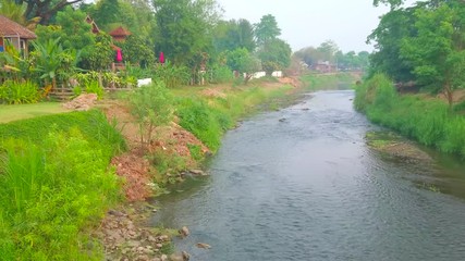 Wall Mural - Enjoy the nature of Pai mountain resort, walking by Pai river with beautiful banks, covered with greenery, Thailand 