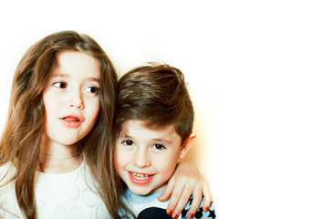 little cute boy and girl hugging playing on white background, happy smiling family, lifestyle people concept close up