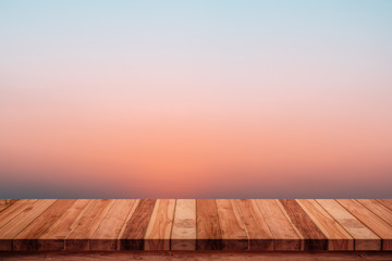 Wall Mural - empty wooden table with abstract gradient sunrise in the sky natural background.