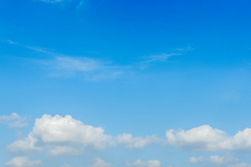 white clouds on a bright day with a blue sky in the background