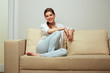 © Yuriy Shevtsov - woman relaxing at home sitting on sofa.