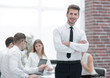 © ASDF - young businessman standing in modern office