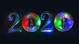 Fototapeta Mapy - The concept of 2020 on the topic of cryptocurrency. Multi-colored bitcoin coins stand next to the numbers 2. Black background