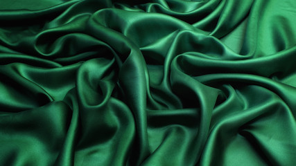 Silk satin fabric. Green colour. Texture, background, pattern.