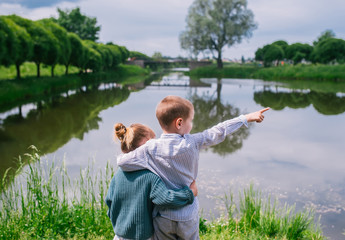 Young boy and girl looking at the lake