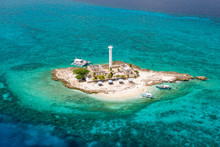 Aerial Drone View Of A Lighthouse On A Tiny Tropical Island Surrounded By Coral Reef And Deep Water (Capitancillo Island, Cebu, Philippines)