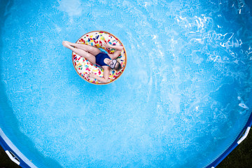 Aerial view of kid in water and summer time 