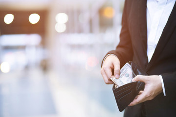 close up business man standing  hand hold Count the money spread of cash. concept finance Saving money.