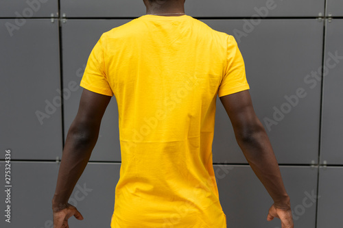Empty Blank Yellow T Shirt On The American Male Back Standing Near Wall Mockup Design Buy This Stock Photo And Explore Similar Images At Adobe Stock Adobe Stock