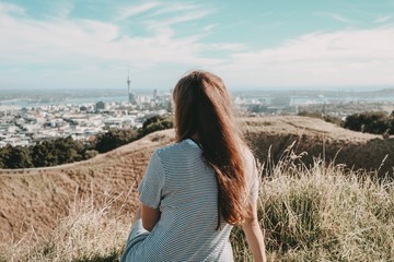 young woman with skyline auckland