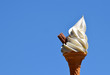 Soft whipped vanilla ice cream in a wafer cone with a chocolate flake