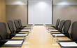 © Mint Images - Projection screen in empty conference room