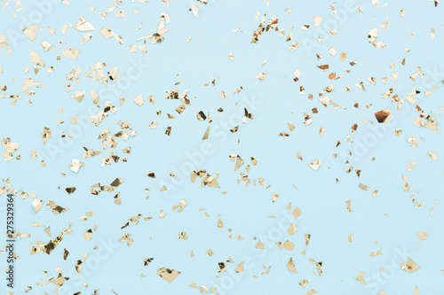 Golden foil confetti on light blue background Poster Mural XXL
