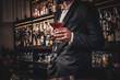 © Fxquadro - Elegant handsome man in classic suit is consuming alcohol at the nice bar.