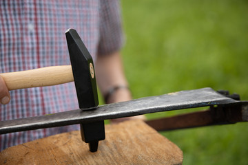 farmer taking care of a scythe