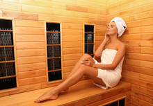 Young Woman Sitting On Wooden Bench In Infrared Sauna, Space For Text. Spa Treatment