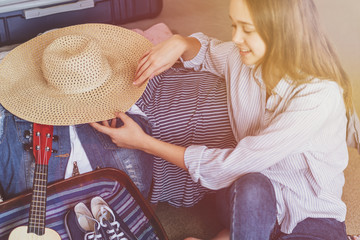 Wall Mural - Female Packing Suitcase And Getting Ready For Traveling. Travel suitcase prepareing concept