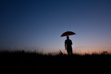 Silhouette Of Man With Umbrella