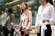 © NDABCREATIVITY - Happy business colleagues talking and walking in the city outdoor