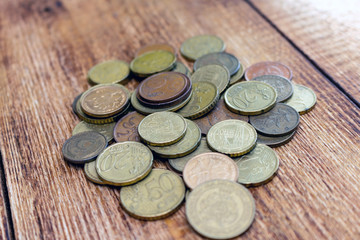 coins old rusty brass euro pile pack heap stack on a wooden background finance economy investment savings concept mock up selective focus close up