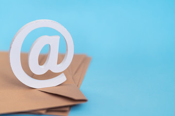 brown envelope with e-mail at sign on blue background