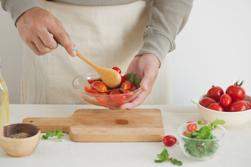 Wall Mural - Tomato salad with spinach, cottage cheese, olive oil and pepper