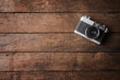 © One Pixel Studio - Old photo camera on wooden background