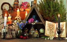 Witch Altar Table With Magic Book, Flowers And Spiritual Objects.