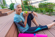 © Dragana Gordic - Sporty woman eating apple. Beautiful woman with gray hair in the early sixties relaxing after sport training. Healthy Age. Mature athletic woman eating an apple after sports training