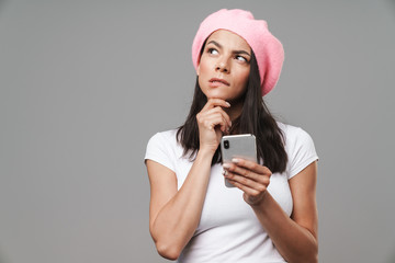 Canvas Print - Attractive young brunette woman wearing beret standing