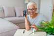 © Dragana Gordic - Blood sugar testing at home. Checking Blood Sugar Level At Home. Diabetic Checking Blood Sugar Levels. Woman checking blood sugar level by glucometer and test stripe at home