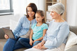 © Syda Productions - family, generation and technology concept - happy mother, daughter and grandmother with tablet computer at home