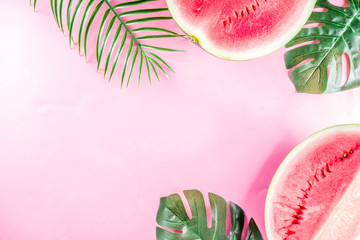 Wall Mural - Creative watermelon layout. Summer trendy bright pattern with sliced watermelon and tropical leaves, Above, flatlay with copy space