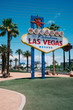 © PR Image Factory - vintage style of wide angle view of famous welcome to fabulous nevada sign standing under blue sky. colorful billboard at southern end of Las Vegas Boulevard and surrounding by beautiful coconut palm
